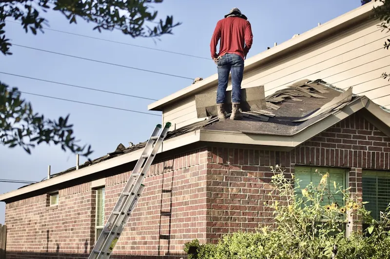 Professional roofer working on a residential roof in Tiffany Woods